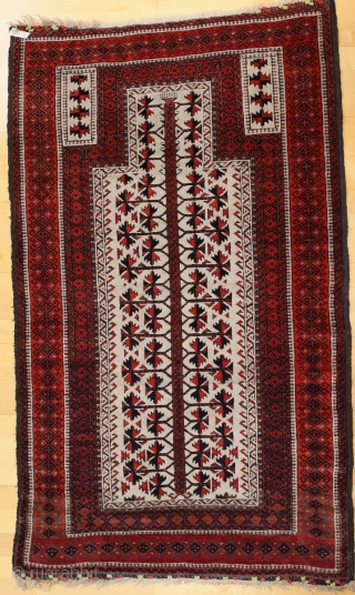 Baluch white ground Prayer rug; beginning 20th c.; 98 x 166 cm (3`3” x 5`5”); one says that Baluch prayer rugs with white ground are rare, this one has also in its  ...