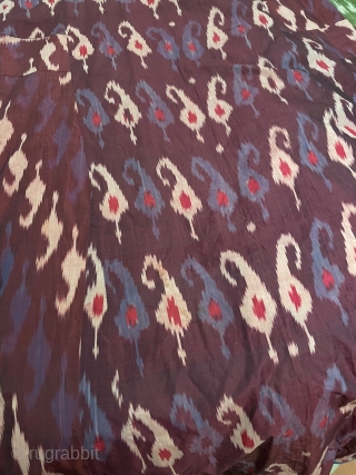Ferghana ikat chapan, very early 20th century. Russian trade cloth cotton lining with striped interior binding and an external finish of blue braid. A panel has been replaced (see photographs)on the left  ...