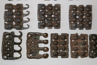 A rare 18 piece group of ancient Tibetan bronze Tokcha armour plates. They appear to be from several different sets. The largest pieces are 82 x 72 mm. and the smallest are  ...