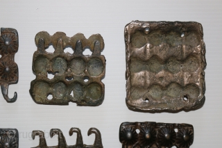 A rare 18 piece group of ancient Tibetan bronze Tokcha armour plates. They appear to be from several different sets. The largest pieces are 82 x 72 mm. and the smallest are  ...
