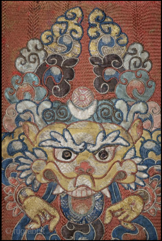 A delightful and very fine Tibetan silk appliqué of Kirrtimukha, or Zpatr. The piece is small and the appliqué elements are likewise very fine. Some areas are embroidered. (see photos) The background  ...