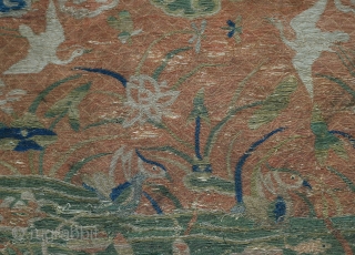 A Ming dynasty sutra cover. Silk embroidered on a gauze ground with design of fish and ducks in a pond with cranes in the sky. The bottom border is hanging jewels and  ...