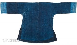 An indigo padded winter jacket for daily use, from Guangxi province, Southwestern China. Cotton, with cotton padding. 19th Century. 134cm x 73cm.

This is a Miao minority jacket, however it is essentially the  ...