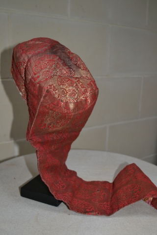 Uzbekistan lady's hat of silk/gilt brocade. The rear hanging portion would have accommodated a pigtail. From the lining late 19th cent / early 20th cent. There is a tarnish across the dome  ...