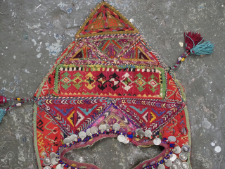 Antique Turkmen child's bib / tunic, decorated with white metal discs and other devices to ward off evil. A beautiful collectors display object.          