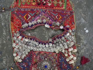 Antique Turkmen child's bib / tunic, decorated with white metal discs and other devices to ward off evil. A beautiful collectors display object.          