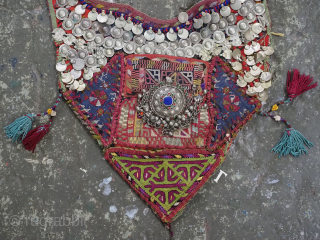Antique Turkmen child's bib / tunic, decorated with white metal discs and other devices to ward off evil. A beautiful collectors display object.          
