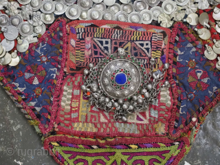 Antique Turkmen child's bib / tunic, decorated with white metal discs and other devices to ward off evil. A beautiful collectors display object.          