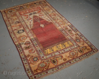 
***£695/$925***
Antique Turkish Oushak region prayer rug of classic design with soft pastel colours. www.knightsantiques.co.uk 
Size: 5ft 11in x 3ft 8in (180 x 111cm). 
Late 19th Century. 

The rug is of a traditional  ...