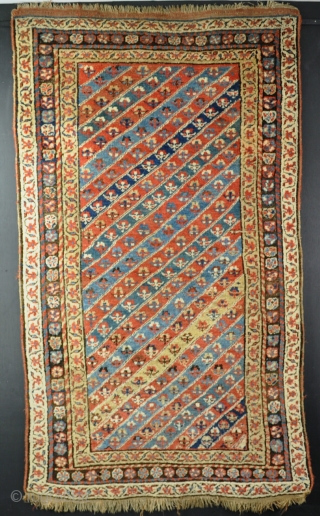 An antique Kurdish rug with attractive all natural dyes. A little moth hole, one small crease, a few spots of corrosion, but mainly in chunky pile. a fresh honest and attractive piece  ...