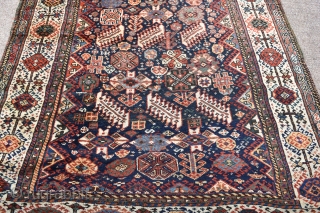 An antique Shekarlu Qasgai rug of unusual small size. Typical design, with a riot of colourful filler elements framed by sunburst borders. A good tribal rug this, with fine silky wool and  ...