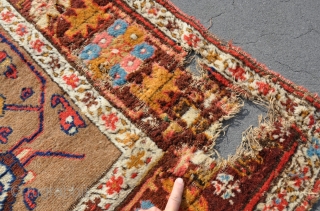A very old Kurdish runner with an unusual pallete and top quality wool.Very good pile, but some big holes down one side and some moth damage, hence price. Great for a restoration  ...