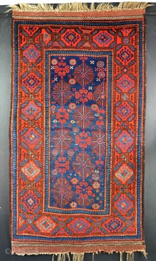 An Old Quchan Kurd rug, good dyes and shiney wool, clean, good condition and floor ready. Velcro hanging sysetm to rear. Circa 1900. 187x104cm         