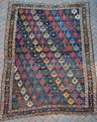 An early Kurdish carpet with  at least 12 fabulous colours. Cut and shut at both ends (doesent realy show), some local wear, filthy dirty, but plenty of fat glossy pile. Very  ...