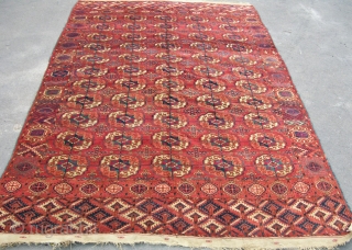 An antique Tekke main with particularly pleasing ground color. A few small holes and some small reapirs that need re-doing, but in full pile with original attractive kilim ends and sides. Ripe  ...