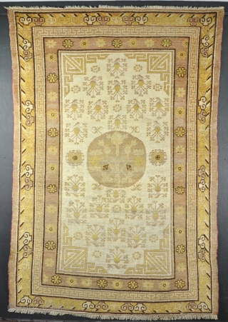 An antique Khotan rug with very soft colours. The size is unusually square. Good soft pile, slight wear in places, very clean and handsome example. 220x147cm       