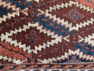 Yomud Turkoman Asmalyk, late 19th century, 2-1 x 3-8 (64 x 112), rug was hand washed, good pile, left edge has long  tare, 4-5 small holes, 4 green silk highlights in  ...