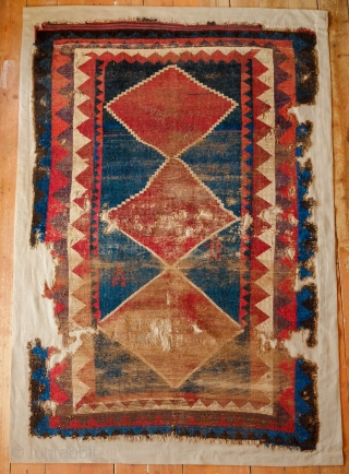 Qashqa'i Gabbeh, Mid 19th Century. Beautiful saturated colors including a rich purple in one of the serrated borders.  Two human figures woven into the field.  The design forms a mihrab  ...