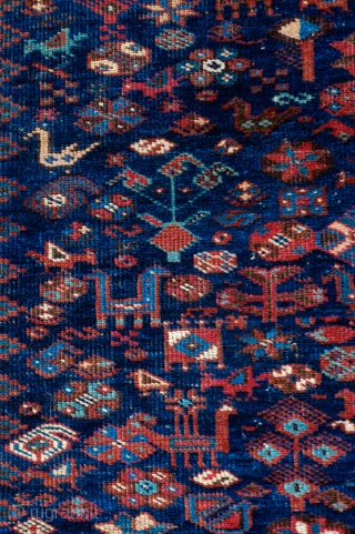 Khamseh Rug, Late 19th/early 20th Century.  Fantastic deep indigo blue ground.  Exceptional border.  Natural colors.  Possibly Arab Jabbareh group but the knots are symmetrical.  171 x 212  ...