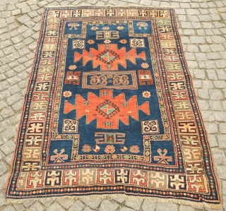 Karachof Kazak rug, 19th century.  Mellower shades in natural dyes.  In good condition with a reconnected tear at the bottom and some slightly lower pile in the medallions.    ...