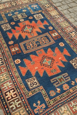 Karachof Kazak rug, 19th century.  Mellower shades in natural dyes.  In good condition with a reconnected tear at the bottom and some slightly lower pile in the medallions.    ...