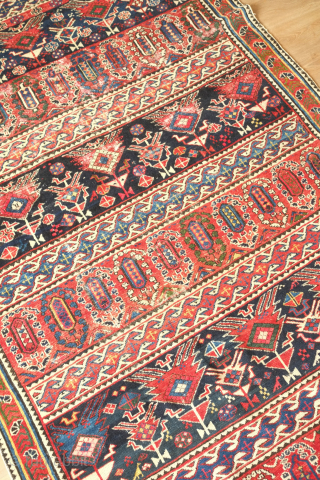 Shirvan rug, 19th century.  Botehs and shrubs of life or shrubbery of a general nature flanked by birds.  The weave is fine.  A section of wear in one of  ...