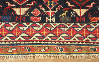 Shirvan rug, 19th century.  Botehs and shrubs of life or shrubbery of a general nature flanked by birds.  The weave is fine.  A section of wear in one of  ...