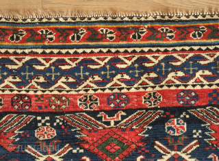 Shirvan rug, 19th century.  Botehs and shrubs of life or shrubbery of a general nature flanked by birds.  The weave is fine.  A section of wear in one of  ...