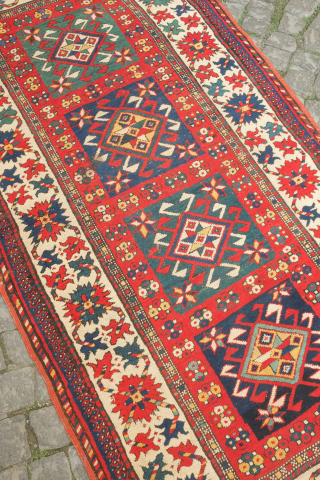 Kazak rug, 3rd to 4th quarter of the 19th century.  Hooked medallions in squares and a crab leaf border.  Good pile and general condition. 110 x 224 cm   