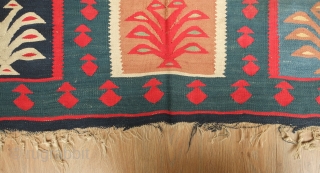 Sarkoy kilim, 19th century.  Nine niches with bird-headed trees of life topped with an evil eye or sun motif on a green ground.  In general very good condition. 108 x  ...