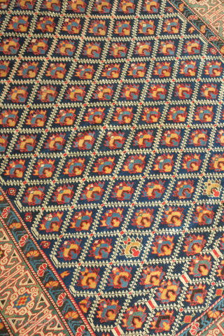 Kuba rug, 19th century.  Deep indigo ground with green, yellow, blue, pink and purple palmettes.  Green main border with kufic motifs.  Excellent condition. 150 x 178 cm   