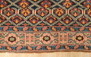 Kuba rug, 19th century.  Deep indigo ground with green, yellow, blue, pink and purple palmettes.  Green main border with kufic motifs.  Excellent condition. 150 x 178 cm   