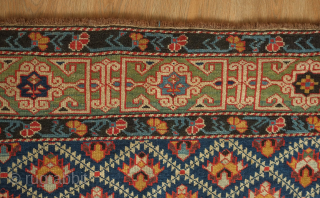 Kuba rug, 19th century.  Deep indigo ground with green, yellow, blue, pink and purple palmettes.  Green main border with kufic motifs.  Excellent condition. 150 x 178 cm   