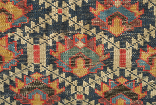 Kuba rug, 19th century.  Deep indigo ground with green, yellow, blue, pink and purple palmettes.  Green main border with kufic motifs.  Excellent condition. 150 x 178 cm   