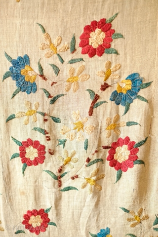 Ottoman Embroidery, 18th Century. Overall floral motif in strong, vibrant colors in silk on linen. The maroon-brownish silk has been coroded in the stems and border outlines. This is a complete suzani.  ...