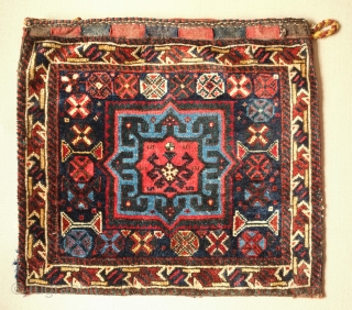 Shiraz saddle bag, one side, 19th century.  Lustrous wool.  Excellent drawing in the central medallion which floats on the field and other motifs.  Dark duck head green in the  ...