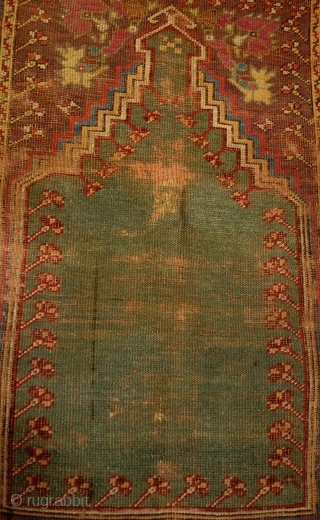 Mudjur Prayer Rug, Late 18th Century. Incredible colors. It contains a solid green field representing the heavens crested with a stunning cloud band. It is worn all over but its design elements  ...