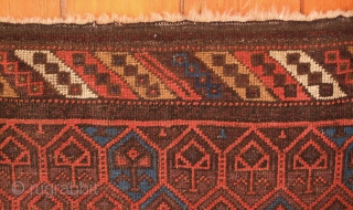 Aimaq "Baluch" Rug, Late 19th Century.  Dokhtar-e Ghazi variant design.  The repeat floral motif is also similar to those that appear on Seljuk rugs.  The repeated pattern is broken  ...