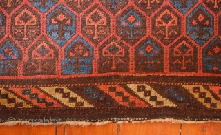 Aimaq "Baluch" Rug, Late 19th Century.  Dokhtar-e Ghazi variant design.  The repeat floral motif is also similar to those that appear on Seljuk rugs.  The repeated pattern is broken  ...