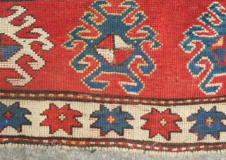 Kazak prayer rug, dated to about 1876. The date is inscribed at the top of the mihrab. 
Note the abstracted beast to the left of the top of the mihrab. Also note  ...