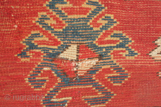 Kazak prayer rug, dated to about 1876. The date is inscribed at the top of the mihrab. 
Note the abstracted beast to the left of the top of the mihrab. Also note  ...