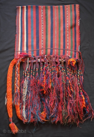 Tribal baby carrier, Kurdish from eastern Anatolia. 1920s or so.  It adorned with long braided tassels and additional filikli or long goat hair tassels.  A thick, hand braided band has  ...