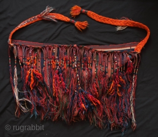 Tribal baby carrier, Kurdish from eastern Anatolia. 1920s or so.  It adorned with long braided tassels and additional filikli or long goat hair tassels.  A thick, hand braided band has  ...