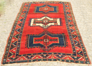 Kazak rug, late 19th century.  Deeply saturated colors with fluidly drawn serrated decagons. The organic quality of these medallions and other design elements almost gives this rug the feel of a  ...