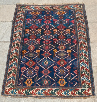 Shirvan or Kuba Rug, Late 19th Century. Blue ground with two shades of blue in a lattice and very minimized Afshan design.  The border is in a compound split leaf border.  ...