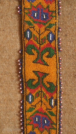 Sivas area glass beaded belt from the 1920s to 1930s. Yellow ground. Beautifully articulated floral motifs, Turkmen gol-like medallions and a rooster on each end.  Leather backing.  5.5 x 74  ...