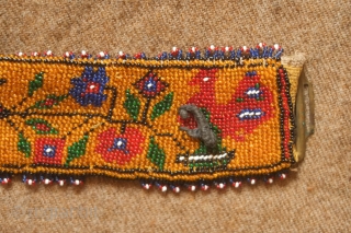 Sivas area glass beaded belt from the 1920s to 1930s. Yellow ground. Beautifully articulated floral motifs, Turkmen gol-like medallions and a rooster on each end.  Leather backing.  5.5 x 74  ...