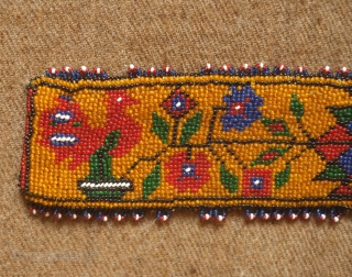 Sivas area glass beaded belt from the 1920s to 1930s. Yellow ground. Beautifully articulated floral motifs, Turkmen gol-like medallions and a rooster on each end.  Leather backing.  5.5 x 74  ...