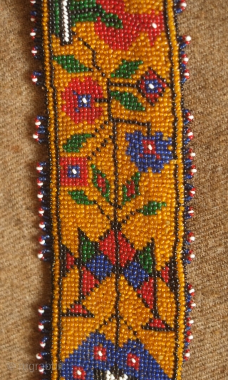 Sivas area glass beaded belt from the 1920s to 1930s. Yellow ground. Beautifully articulated floral motifs, Turkmen gol-like medallions and a rooster on each end.  Leather backing.  5.5 x 74  ...