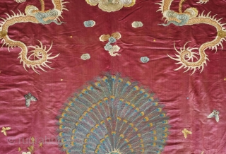 Qing Chinese hanging, late 19th century. The fabulous peacock tands with opened tail in exceptional embroidered detail with two dragons facing each other above.  The dragons are four clawed and are  ...